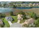 An aerial shot showcasing the property's prime location on a lush green lot with scenic lake views at 8910 Jericho Rd, Weeki Wachee, FL 34613