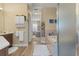 Bathroom showcasing modern vanities, a soaking tub, and a glass-enclosed shower, while a hallway leads to the bedroom at 8910 Jericho Rd, Weeki Wachee, FL 34613