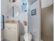 Dual shot of a well-lit bathroom with a vanity sink, toilet, and shower at 8910 Jericho Rd, Weeki Wachee, FL 34613