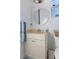 Well-lit bathroom features a vanity sink, round mirror, and modern fixtures at 8910 Jericho Rd, Weeki Wachee, FL 34613