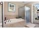 Elegant bathroom features a soaking tub, glass-enclosed shower, and access to a screened patio, creating a spa-like retreat at 8910 Jericho Rd, Weeki Wachee, FL 34613