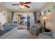 Bright bedroom with access to the patio offers a cozy seating area, ideal for relaxing or reading at 8910 Jericho Rd, Weeki Wachee, FL 34613