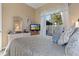 Comfortable bedroom featuring a large window, dresser, and patterned bedding at 8910 Jericho Rd, Weeki Wachee, FL 34613