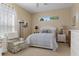 Cozy bedroom with a large window providing natural light, comfortable chair, and neatly decorated with a plush bedspread at 8910 Jericho Rd, Weeki Wachee, FL 34613