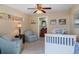 Comfortable bedroom featuring a ceiling fan and an ensuite bathroom, designed for relaxation and privacy at 8910 Jericho Rd, Weeki Wachee, FL 34613