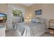Cozy bedroom with a large window, patterned bedding, and modern furniture at 8910 Jericho Rd, Weeki Wachee, FL 34613