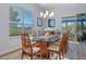 Elegant dining room with a glass-top table, chandelier, and large window at 8910 Jericho Rd, Weeki Wachee, FL 34613