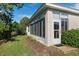 The home's screened in porch and sliding door offer access to the green space at 8910 Jericho Rd, Weeki Wachee, FL 34613