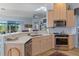 Well-lit kitchen with wooden cabinets, stainless steel appliances and hardwood flooring at 8910 Jericho Rd, Weeki Wachee, FL 34613