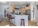Cozy kitchen showcasing bar seating, stainless steel refrigerator, and ample cabinets at 8910 Jericho Rd, Weeki Wachee, FL 34613