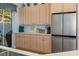 Bright kitchen area with stainless steel fridge, lots of cabinets and countertops at 8910 Jericho Rd, Weeki Wachee, FL 34613
