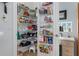 Organized walk-in pantry features ample shelving with food and kitchenware at 8910 Jericho Rd, Weeki Wachee, FL 34613