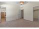 Neutral bedroom with carpet, ceiling fan, and multiple doors and windows at 9514 Highland Ridge Dr, Hudson, FL 34667