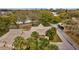 Aerial view of property showcasing manicured landscaping and serene pond at 1002 Caravel Ct, Tarpon Springs, FL 34689