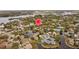 Beautiful aerial view of homes in a lakeside community with mature trees and landscaping at 1002 Caravel Ct, Tarpon Springs, FL 34689