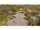 Aerial view showcasing the roof, private deck, landscaping and community at 1002 Caravel Ct, Tarpon Springs, FL 34689