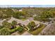 Aerial view of community featuring lush landscaping, mature trees and serene pond at 1002 Caravel Ct, Tarpon Springs, FL 34689