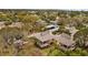 Aerial view showcases community amenities, lush surroundings, and serene pond at 1002 Caravel Ct, Tarpon Springs, FL 34689