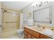 Well-maintained bathroom features a tub-shower combo with a tile surround and a wooden vanity at 1002 Caravel Ct, Tarpon Springs, FL 34689