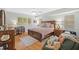 Cozy bedroom features a large bed, a desk area, and lots of natural light from shuttered windows at 1002 Caravel Ct, Tarpon Springs, FL 34689