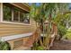 Exterior of home, showing access to deck and patio area. Lush landscaping and natural light at 1002 Caravel Ct, Tarpon Springs, FL 34689