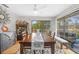 Bright dining room features a large wood table with seating and sliding glass doors leading to a deck at 1002 Caravel Ct, Tarpon Springs, FL 34689