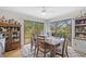 Bright dining room with a wooden table and chairs overlooking outdoor views at 1002 Caravel Ct, Tarpon Springs, FL 34689