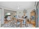 Charming dining room showcases a wooden table, seating for six, and views into the adjacent living room at 1002 Caravel Ct, Tarpon Springs, FL 34689