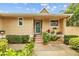 Inviting front entrance with flower pot decor and wood stairs leading to front door at 1002 Caravel Ct, Tarpon Springs, FL 34689