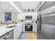 Bright kitchen features white cabinets, stainless steel appliances, and marble countertops at 1002 Caravel Ct, Tarpon Springs, FL 34689