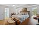 Relaxing main bedroom features a king-size bed, a sitting bench, and an ensuite bathroom at 1002 Caravel Ct, Tarpon Springs, FL 34689