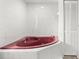 Corner whirlpool tub with tile surround and a large white closet at 1011 Altoona Ave, Spring Hill, FL 34609