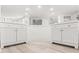 Bright bathroom with dual vanities with white cabinets, sinks and modern hardware at 1011 Altoona Ave, Spring Hill, FL 34609