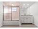 Bright bathroom featuring a vanity with granite counters, modern fixtures and glass enclosed shower at 1011 Altoona Ave, Spring Hill, FL 34609