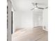 Bedroom with hardwood flooring, a ceiling fan, and a closet door for storage at 1011 Altoona Ave, Spring Hill, FL 34609