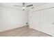 Bedroom featuring hardwood flooring, a ceiling fan, and a spacious closet for ample storage at 1011 Altoona Ave, Spring Hill, FL 34609