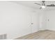 Bedroom featuring hardwood flooring, a ceiling fan, and a closet door for ample storage at 1011 Altoona Ave, Spring Hill, FL 34609