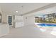 Covered lanai featuring a wet bar area transitions to screened pool, offering seamless indoor/outdoor living at 1011 Altoona Ave, Spring Hill, FL 34609