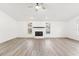 Spacious living room with a tiled fireplace, hardwood floors, and natural light at 1011 Altoona Ave, Spring Hill, FL 34609