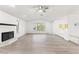 Spacious living area with vaulted ceilings, white walls, wood-look flooring, and a cozy fireplace at 1011 Altoona Ave, Spring Hill, FL 34609