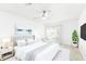 Stylishly furnished main bedroom featuring a ceiling fan, a serene wall art, and sliding glass doors to the lanai at 1011 Altoona Ave, Spring Hill, FL 34609