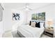 Stylishly furnished main bedroom with a ceiling fan, hardwood floors, and modern decor at 1011 Altoona Ave, Spring Hill, FL 34609