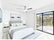 Main bedroom with hardwood flooring, a ceiling fan, and sliding glass doors to the enclosed patio at 1011 Altoona Ave, Spring Hill, FL 34609