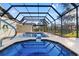 Sparkling pool features a screened enclosure, tile trim and inviting space for relaxation and recreation at 1011 Altoona Ave, Spring Hill, FL 34609