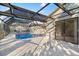 Screened-in pool with covered lanai; perfect for entertaining or relaxing in privacy and comfort at 1011 Altoona Ave, Spring Hill, FL 34609