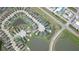 Aerial view of neighborhood and roadways featuring many residences and pond at 11611 Lake Blvd, New Port Richey, FL 34655