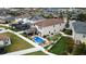 Aerial view of a two-story house and backyard with pool and privacy fence and mature landscaping at 11611 Lake Blvd, New Port Richey, FL 34655