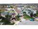 Beautiful two-story home with green landscaping and a brick driveway, located near a lake and pool at 11611 Lake Blvd, New Port Richey, FL 34655