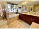 Bright bathroom showcases a garden tub with decorative plants, granite countertop, and tiled floors at 11611 Lake Blvd, New Port Richey, FL 34655