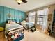 Charming ' bedroom with two twin beds, blue accent wall, and natural light at 11611 Lake Blvd, New Port Richey, FL 34655